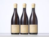 three bottles of wine sitting on top of a table next to each other