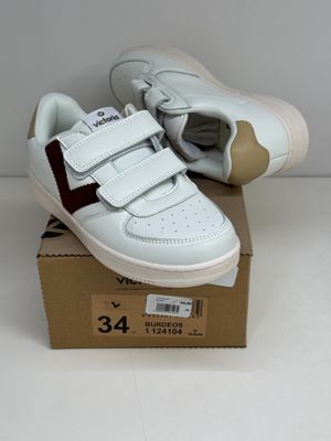 a box with a pair of white shoes on it