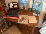 a desk with books and a chair in a room
