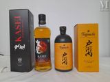 three bottles of sake and a box of sake sit on a table
