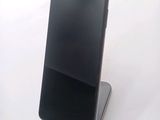a cell phone that is sitting on top of a stand