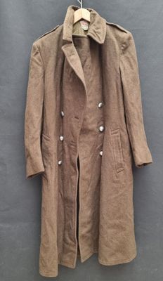 an image of a coat hanging on a hanger on a wall