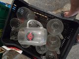 a plastic container filled with empty glasses in a basket