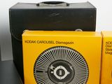 two boxes of kodak carousels and a black and yellow box