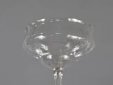a wine glass sitting on top of a table