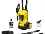 a yellow and black pressurer with a hose and other cleaning supplies