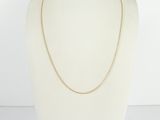a gold chain necklace on a mannequin mannequin