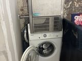a washer and dryer in the corner of a room