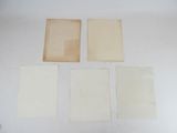 four pieces of paper are sitting on top of a table
