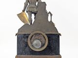 a statue of a man on top of a clock