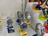 a lot of watches on display in a glass case