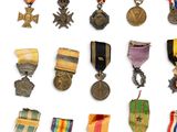 an assortment of medals and medals are displayed on a white surface