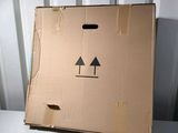 a cardboard box with a face on it sitting on a table