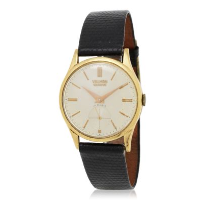 a close up of a gold and black watch on a white background