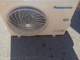 an air conditioner sitting on the ground in front of a pile of boxes