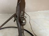 un pistolet posé sur un support au sol