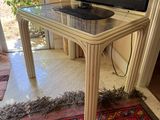 a flat screen tv sitting on top of a glass table