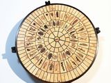 a picture of a clock made out of wine corks on a wall