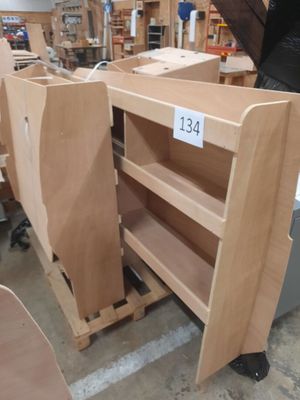 a person standing in a room with a lot of wooden furniture