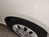 a close up of a white car with a black rim