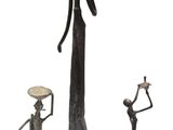 three bronze figurines of a woman holding a bowl and a man holding a bowl