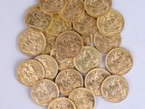 a pile of gold coins sitting on a white surface