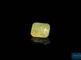 a yellow diamond on a black surface