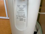 an image of a white electric toothbrush holder in a bathroom