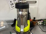 a blender sitting on top of a counter next to a potted plant
