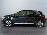 the black car is parked on the concrete floor in the room