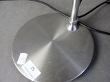 a silver lamp that is on top of a table