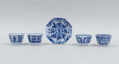 a group of blue and white dishes and cups