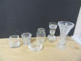 a lot of glass vases sitting on a table