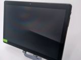 a tablet computer sitting on a stand on a table