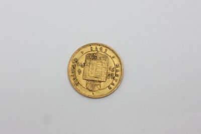 une pièce d'or sur laquelle figure l'image d'un homme