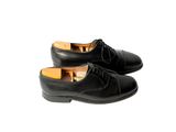pair of black leather shoes with laces on a white background