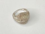 a close up of a silver ring on a white surface