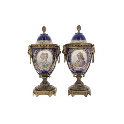 two blue vases with a picture of a woman and a man on them