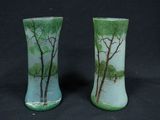 two vases with trees painted on them on a black background