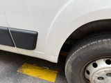a white van that is parked on the side of the road
