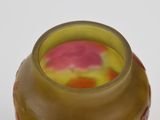 a vase with a flower inside of it on a table