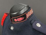 a close up of a military uniform with a red and black collar