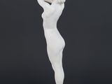 a white statue of a woman holding a baseball bat on a black background
