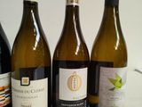 several bottles of wine are lined up on a table