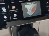 a coffee machine that has a cup of coffee on it