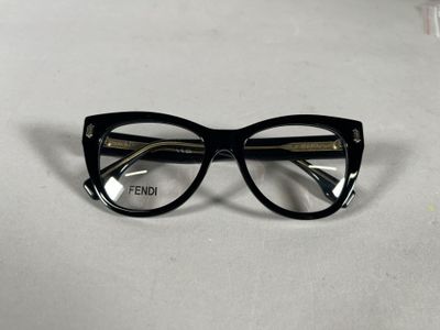 black cat eye glasses with clear lenses on a white surface