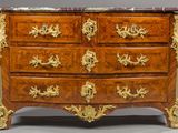 an antique chest of drawers with a marble top and gold decoration