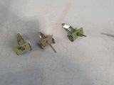 three small pieces of metal sitting on a table