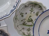 many plates and bowls that are on a table