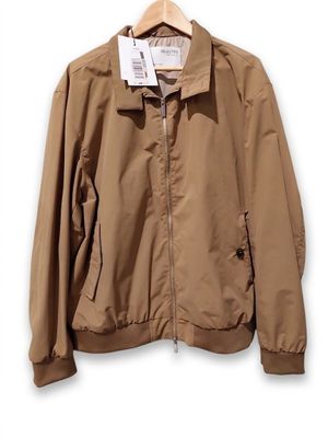 an image of a jacket hanging on a hanger on a wall